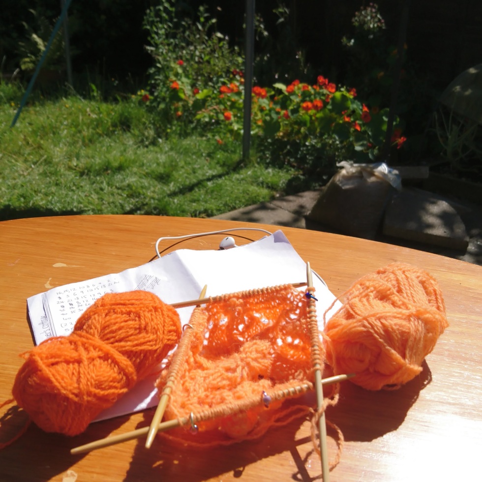 Knitting in the garden with flowers in the background